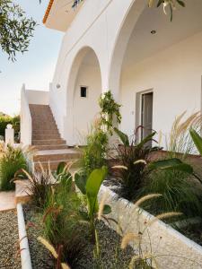 a white house with stairs and plants at Seascape Nafplio Residence in Vivari