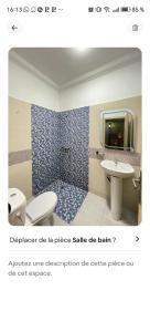 a bathroom with a sink and a toilet and a tv at Benjelloun in Marrakesh