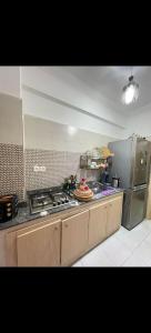 a kitchen with a stove top and a refrigerator at Benjelloun in Marrakesh