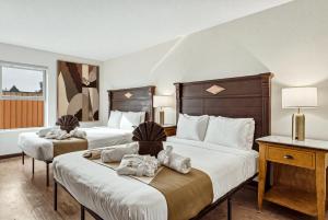 a hotel room with two beds with towels on them at LUXX Taos Motor Lodge in Taos +85 photos