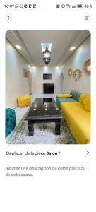 a living room with a yellow couch and a coffee table at Benjelloun in Marrakesh