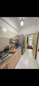 a kitchen with a counter and a stove top oven at Benjelloun in Marrakesh +33 photos