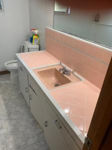 a bathroom with a sink and a toilet at 4 Room Sleeps 8plus Tranquil Home in Santa Cruz