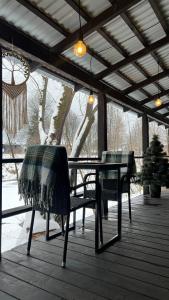 a patio with a table and chairs on a porch at Molfar green 