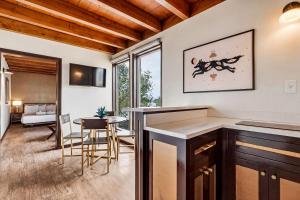 a kitchen and living room with a table and chairs at LUXX Taos Motor Lodge in Taos