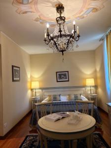 a room with a bed and a chandelier at Le Muse Hotel in San Bonifacio +57 photos