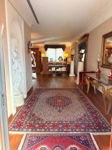 a living room with a rug on the floor at Le Muse Hotel in San Bonifacio