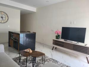a living room with a flat screen tv and a couch at Nuevo Vallarta Peaceful Loft in Nuevo Vallarta