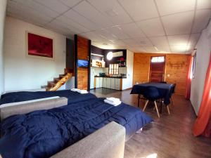 a bedroom with a bed and a dining room with a table at Casa Petricor in Río Tercero