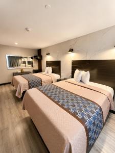 a hotel room with two beds in it at TREMONT HOTEL BRONx-GRAND OPENING in Bronx +34 photos