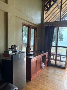 a kitchen with a stove and a refrigerator in a room at The Sunrise Point in Katiet +43 photos