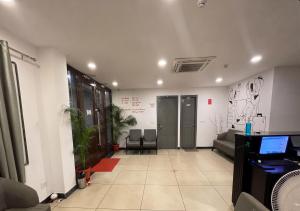 an office with a waiting room with a couch and chairs at Hotel A P S Townhouse in Prayagraj +20 photos