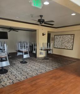 a conference room with tables and chairs and a projection screen at Super 10 Fairgrounds, I-40, Airport in Oklahoma City