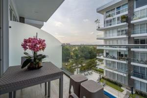 a balcony with a table with a vase of flowers on it at Nuevo Vallarta Peaceful Loft in Nuevo Vallarta
