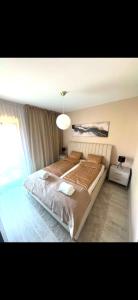 a bedroom with a large bed and a large window at Luxiva Home in Nyíregyháza
