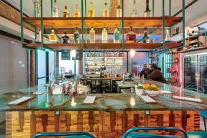 a bar in a restaurant with a counter and chairs at Schaeffer Hotel in New Orleans
