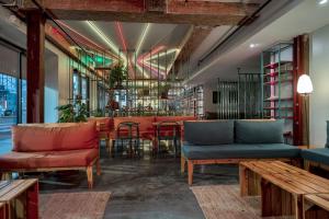 a restaurant with couches and tables and a bar at Schaeffer Hotel in New Orleans +9 photos