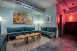a living room with two blue couches and a table at Schaeffer Hotel in New Orleans