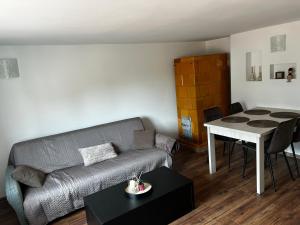 a living room with a couch and a table at Nadmorska Przystań in Ustka