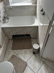 a bathroom with a tub and a toilet and a sink at Nadmorska Przystań in Ustka