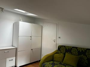 a living room with a couch and a white cabinet at Nadmorska Przystań in Ustka
