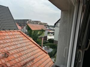 a view of the roofs of buildings from a window at Nadmorska Przystań in Ustka