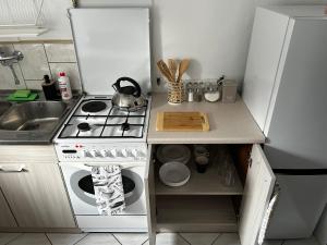 a small kitchen with a stove and a sink at Nadmorska Przystań in Ustka +2 photos