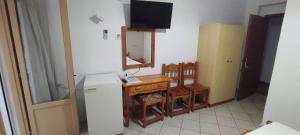 a kitchen with a small table and a refrigerator at Ariadni Fountas Studios in Parga