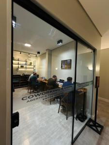 a group of people sitting at a table in an office at Igaras Hotel - Centro de Otacílio Costa, 49km de Lages in Otacílio Costa
