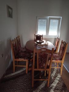 a dining room table and chairs in a room at Ema in Bajina Bašta +3 photos