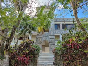 a house with trees in front of it at Condumel in Cozumel