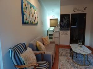 a living room with a couch and a table at Cosy Stay in Robertson