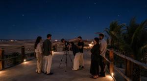 a group of people looking at the night sky at Sunset Agafay Resort in El Karia
