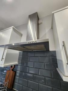 a kitchen with a stainless steel stove top oven at The Willow in Aveley
