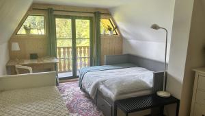 a bedroom with a bed and a large window at Chata za dubem in Všelibice