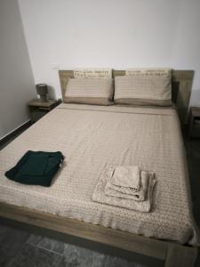 a bed with a blanket and a robe on it at Due Orizzonti in Monsampolo del Tronto