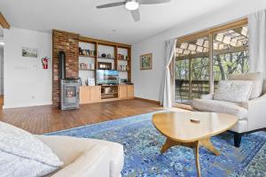 a living room with a couch and a table at Spacious House with Modern Comforts and Nature in Cushing