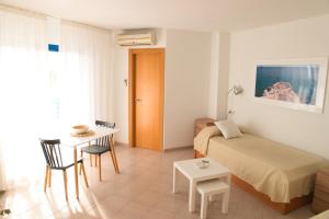 a bedroom with a bed and a desk and a table at Apartamentos la barca in Benidorm +15 photos