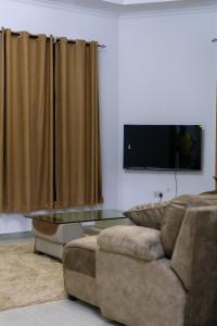 a living room with a couch and a glass table at Mwisongo Homestay in Morogoro