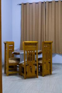 a table and two chairs and a table and a curtain at Mwisongo Homestay in Morogoro