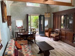 a living room with a couch and a table at Cozy Cottage in Utrecht