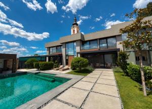 a house with a swimming pool and a tower at Diwine Spa House Fruška Gora in Irig