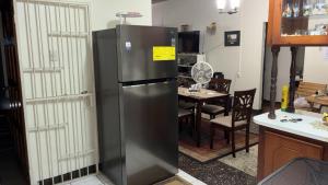 a stainless steel refrigerator in a kitchen with a table at The Doctor's Quarters DQ in San Fernando +2 photos