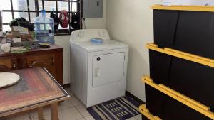 a small white washer and dryer in a room at The Doctor's Quarters DQ in San Fernando