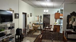 a living room with a couch and a tv at The Doctor's Quarters DQ in San Fernando