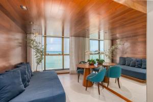 a living room with a blue couch and a table at HY Apartaments & Hotels-Boa Viagem in Recife
