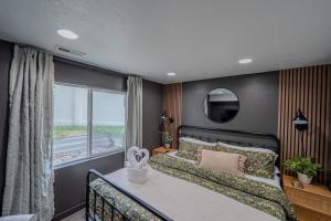 a bedroom with a large bed and a window at Modern Basement Apartment King Bed and Full Kitchen in Bluffdale