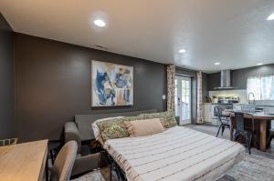 a living room with a couch and a kitchen at Modern Basement Apartment King Bed and Full Kitchen in Bluffdale +22 photos
