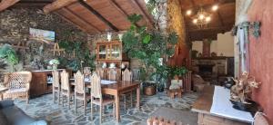 a dining room with a table and some plants at Casa Vixide in Lalín