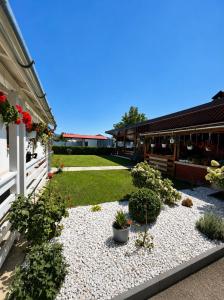 a courtyard of a building with flowers and plants at CAZARE TURISM PRISLOP in Haţeg +7 photos